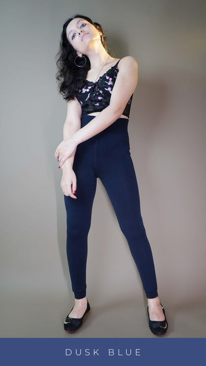 A model wearing stylish dusk blue furry tights paired with a black top showcasing the luxurious plush texture and trendy appeal. Perfect for adding warmth and elegance to any outfit. -Muselot






