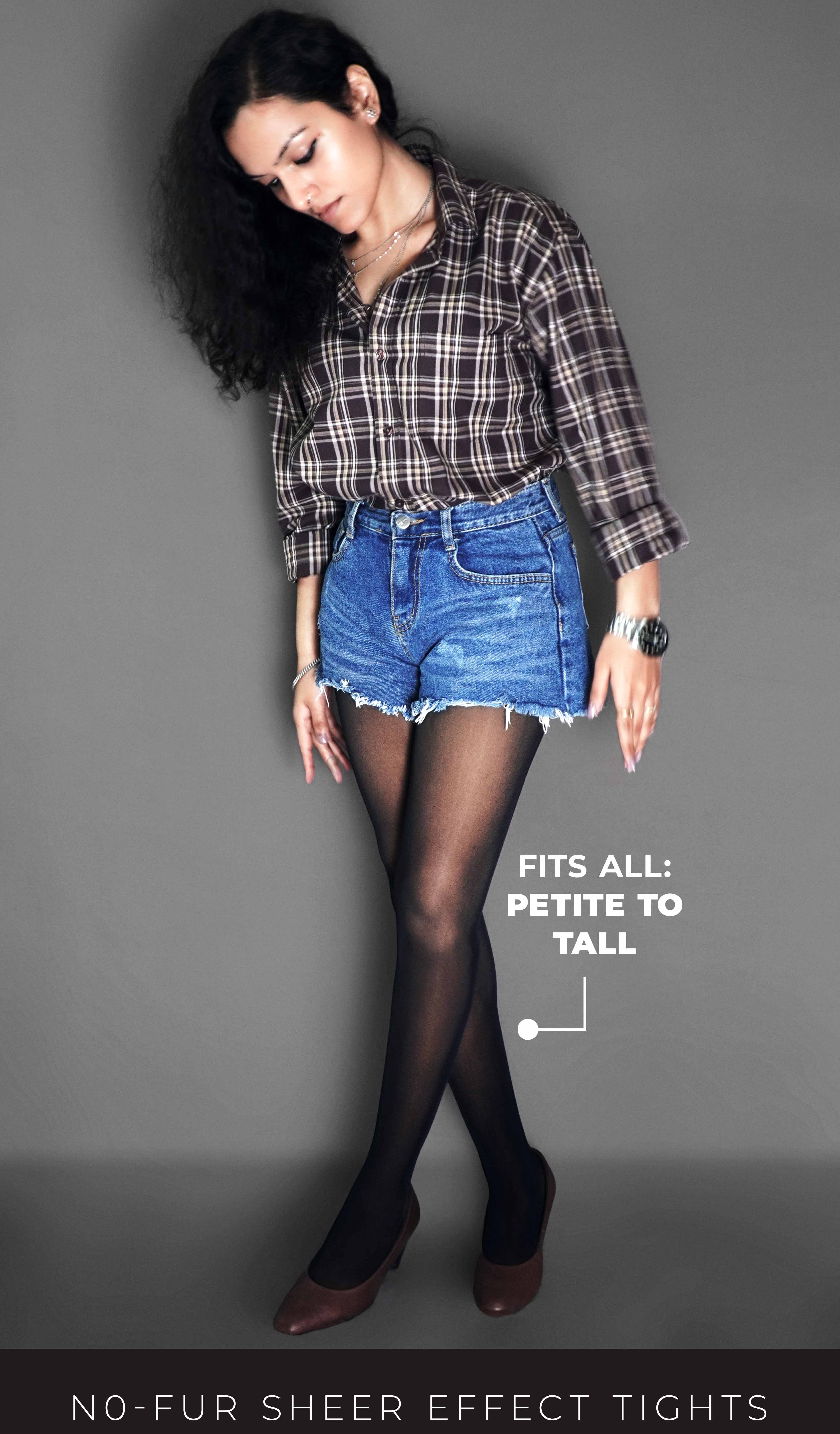 A woman wearing skin lined sheer stockings, paired with a denim shorts and brown heels, she is looking downward at her tights, highlighting the durable smooth material-Muselot