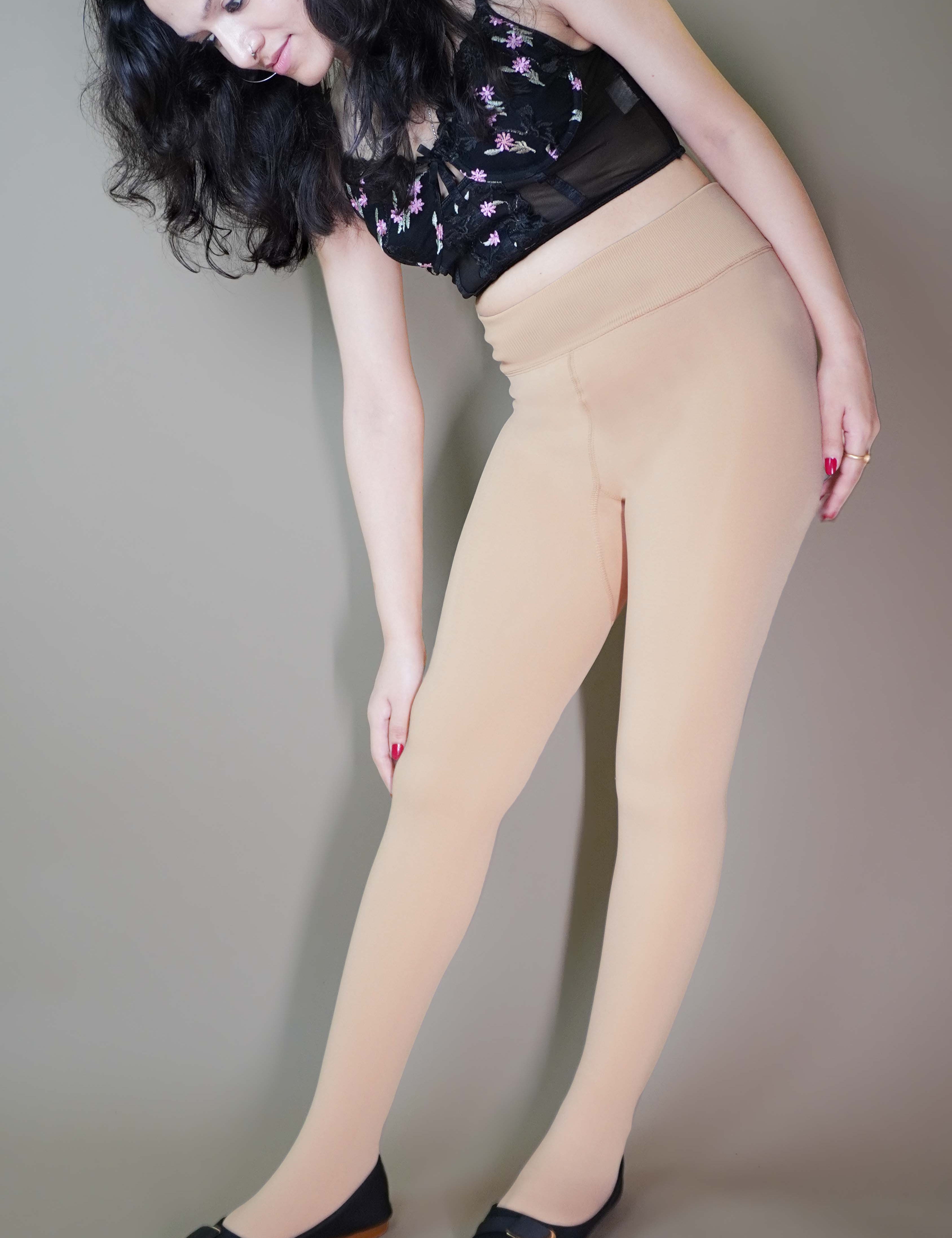 A model, wearing stylish skin warm tights, showcasing their sleek, form-fitting design that provides warmth while maintaining a natural, seamless look-Muselot