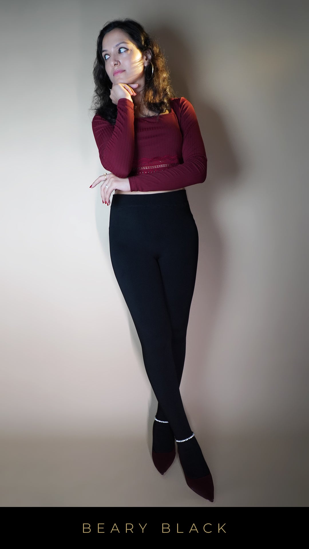 A model, wearing stylish warm velvety black tights, showcasing their soft, luxurious texture that offers both warmth and elegance. The velvety finish and deep black color highlight a chic, sophisticated look, perfect for adding a touch of luxury to any cold-weather outfit. -Muselot