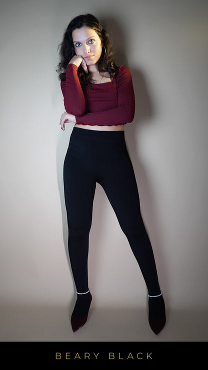 A model, wearing velvety cozy warm black tights, showcasing their soft, luxurious texture that offers both warmth and comfort-Muselot